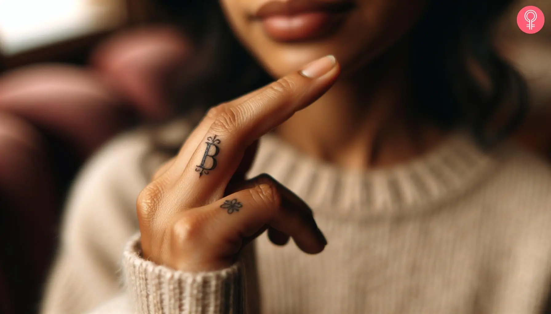 B letter tattoo on a woman’s finger