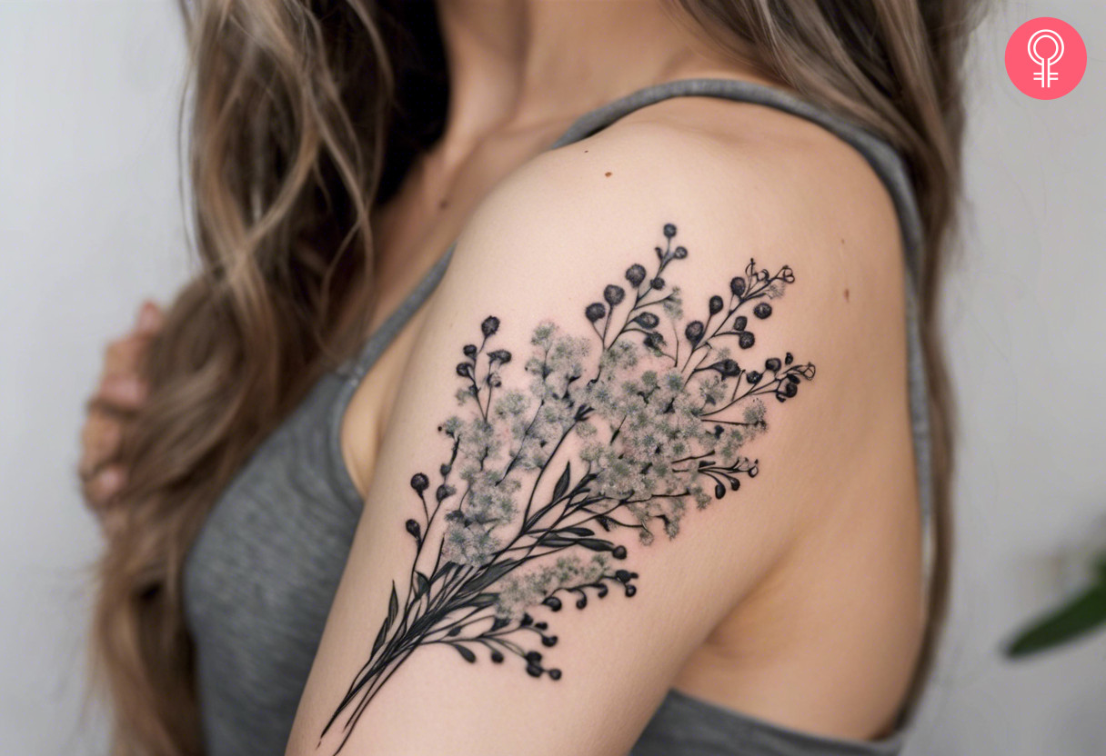 A baby’s breath bouquet tattoo on a woman’s upper arm