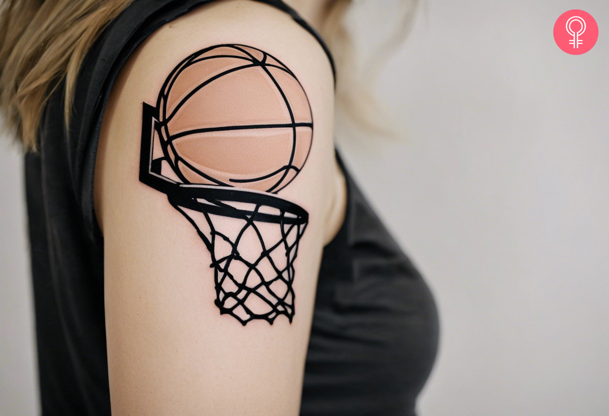 A minimalist basketball hoop tattoo on a woman’s upper arm