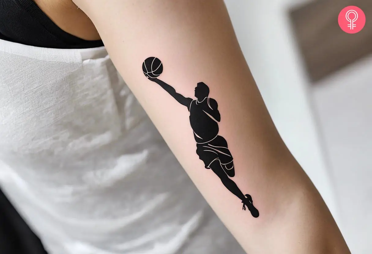 A black basketball player tattoo on a woman’s arm