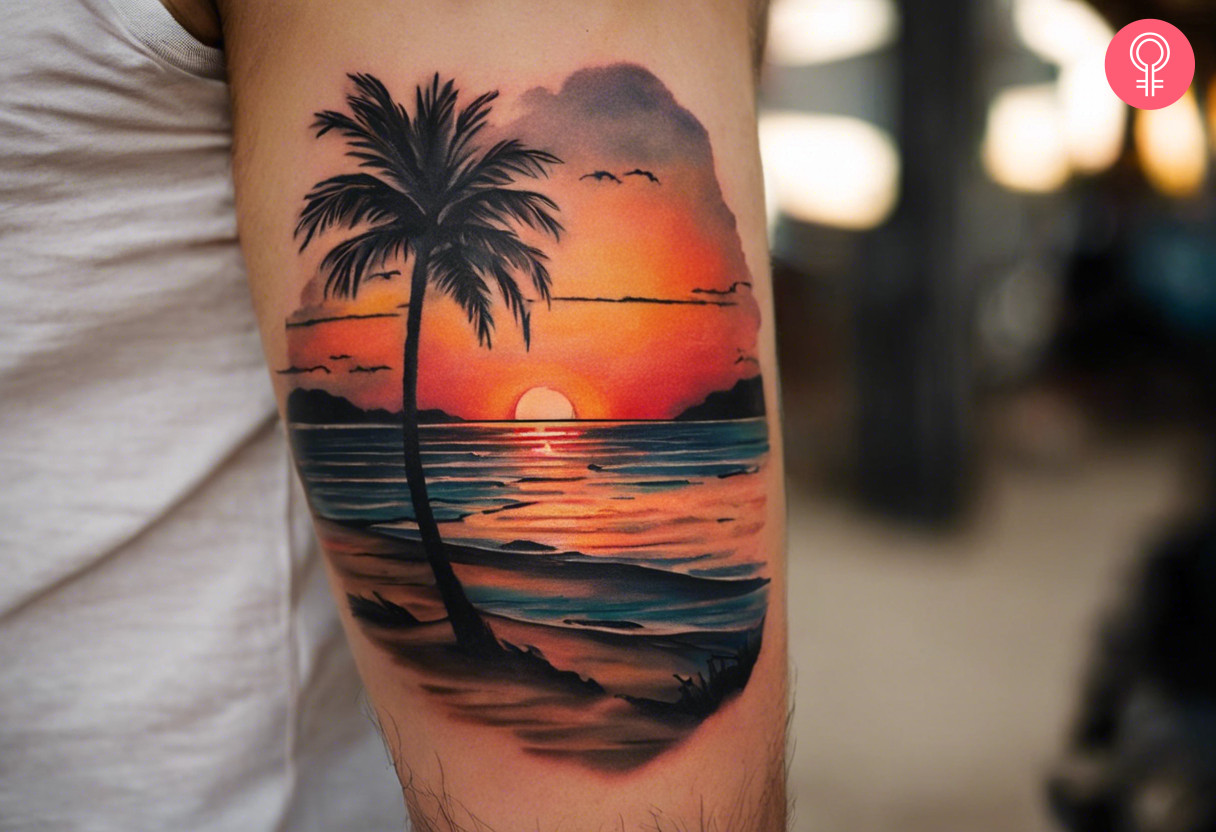 Beach sunset tattoo on the upper arm