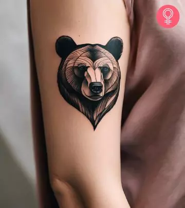 A woman with a bear and cub tattoo on her upper arm