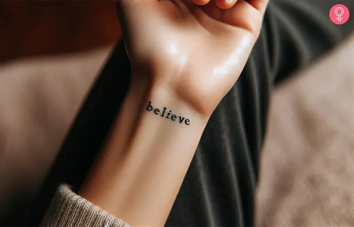 A woman wearing ‘believe’ tattoo on the inner wrist