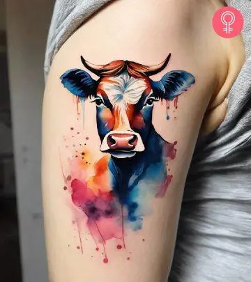 Woman with a bull skull tattoo on the upper arm