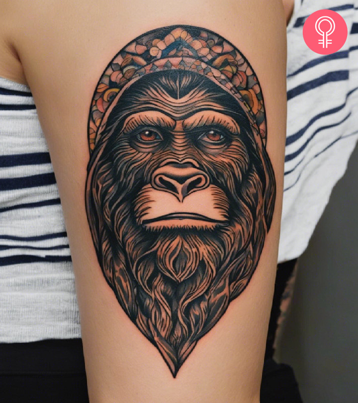 Bigfoot tattoo on the upper arm of a woman