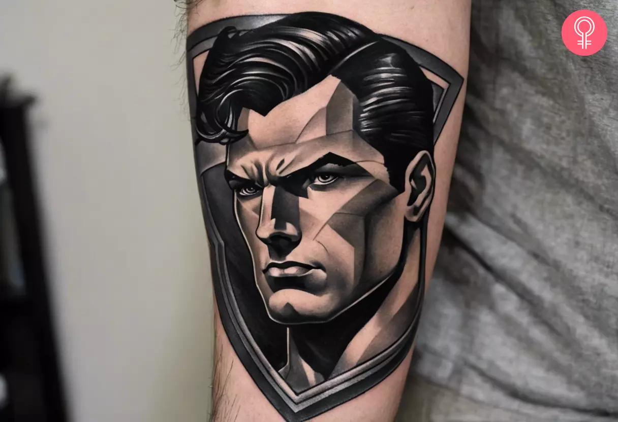 A black and gray Superman tattoo on the upper back