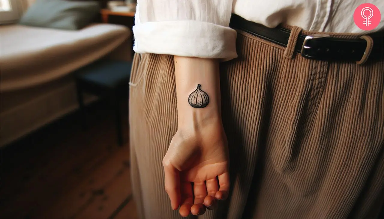 Black-and-white fig tattoo on the wrist