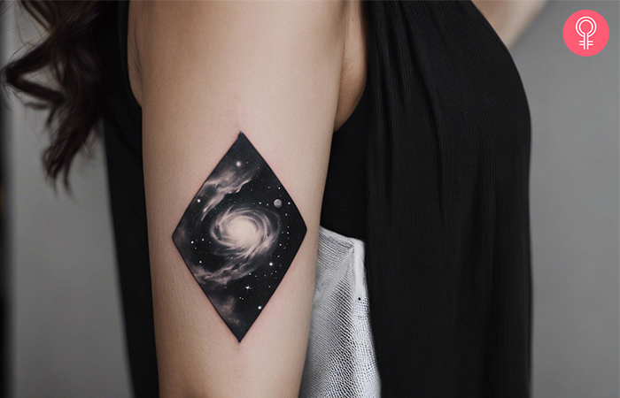 Nebula black and white tattoo on the upper arm