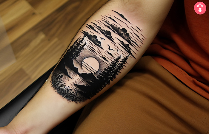 Black-and-white sunset tattoo on the forearm