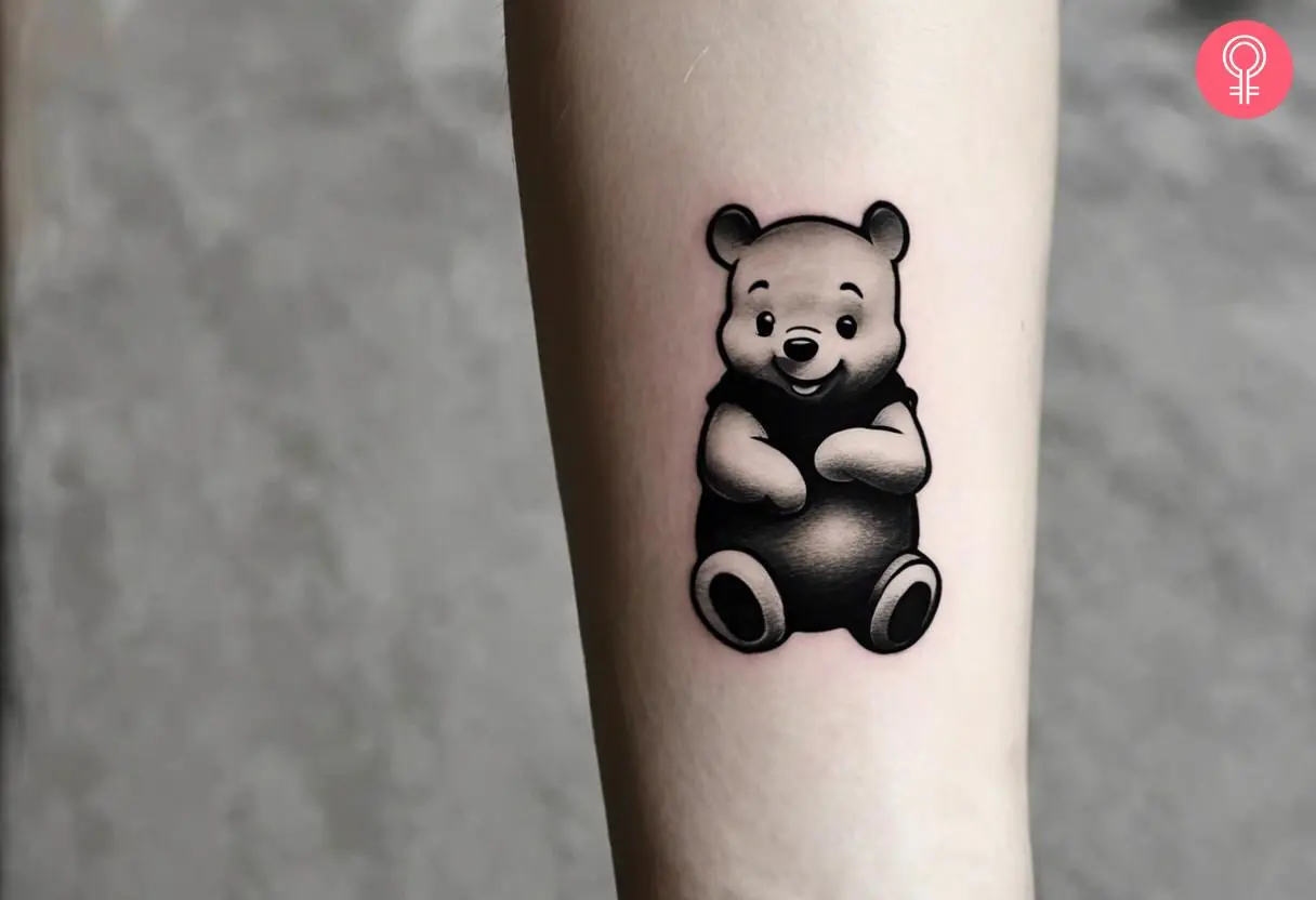 Black and white winnie the pooh tattoo on the forearm