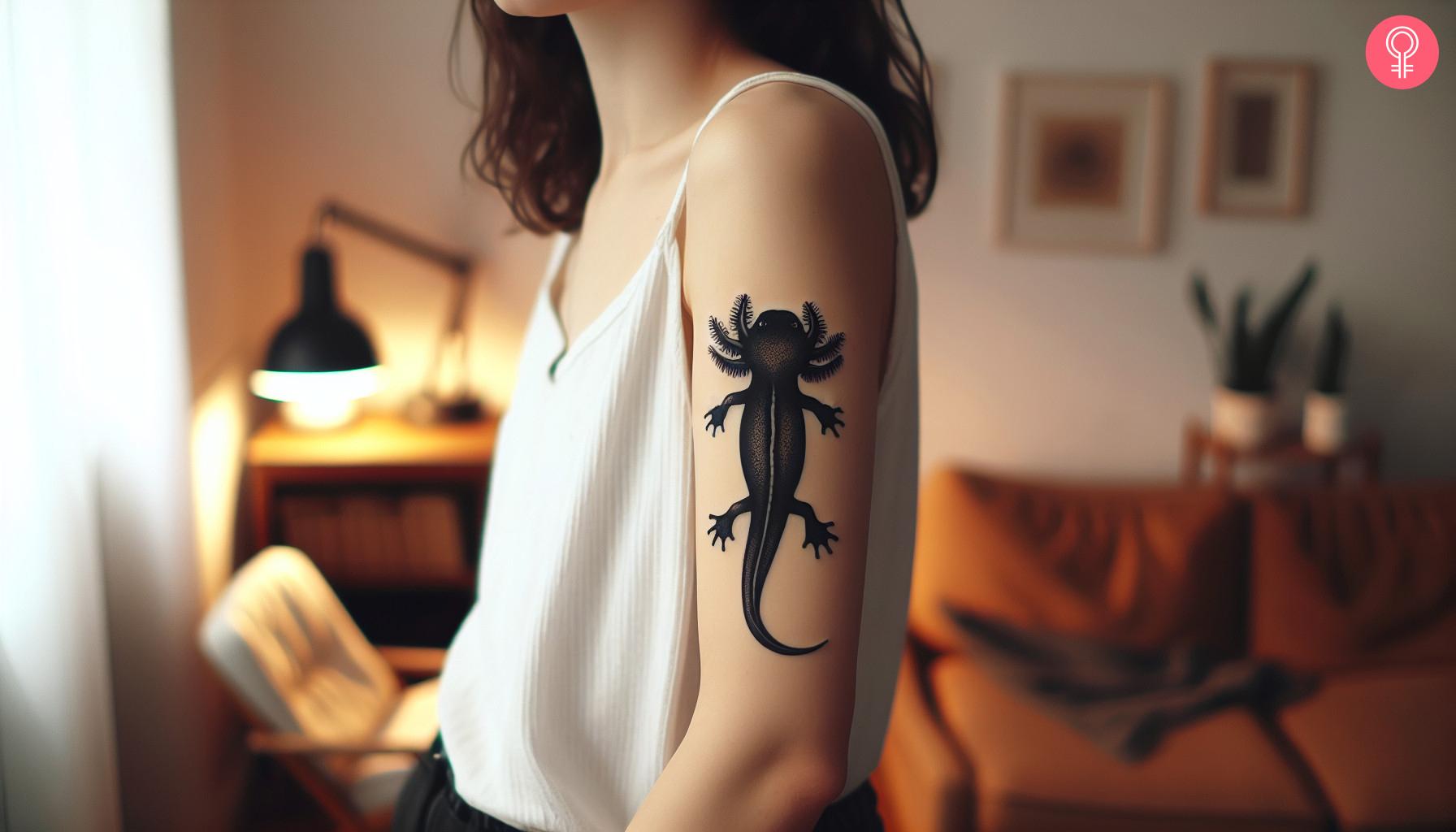 Black Axolotl tattoo on the upper arm