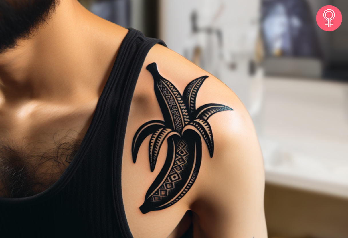 Black banana tattoo on the front shoulder of a man