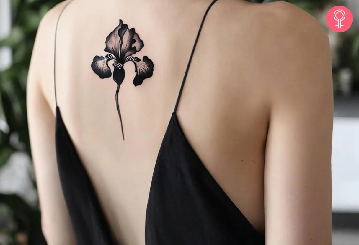 Black iris flower tattoo on the upper back