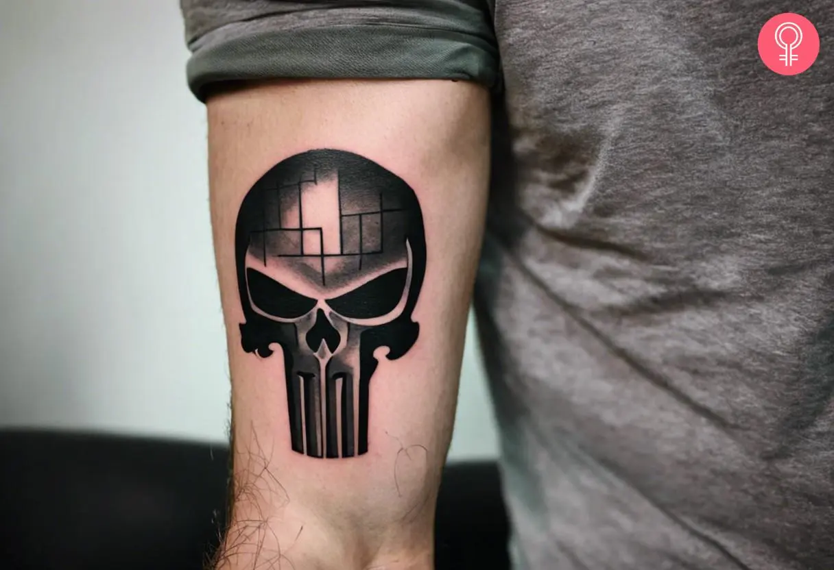 Black punisher skull tattoo on the forearm of a man