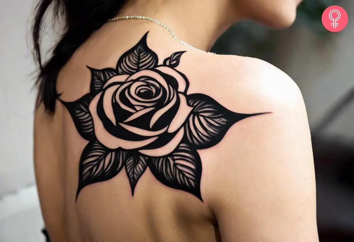 Black rose tribal tattoo on the upper back of a woman