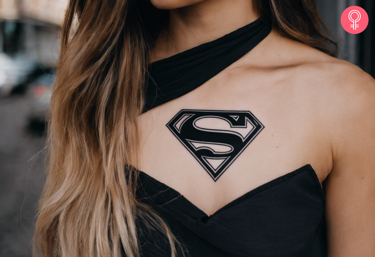 Black Superman tattoo on a woman’s chest