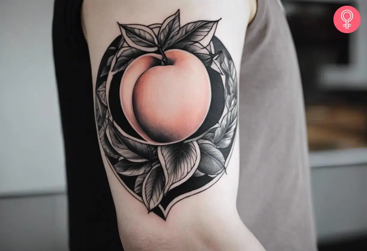 Black and white peach tattoo on the arm