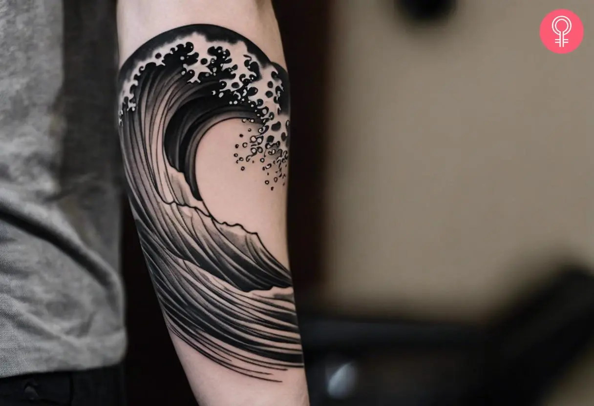 Black and white wave tattoo on the forearm