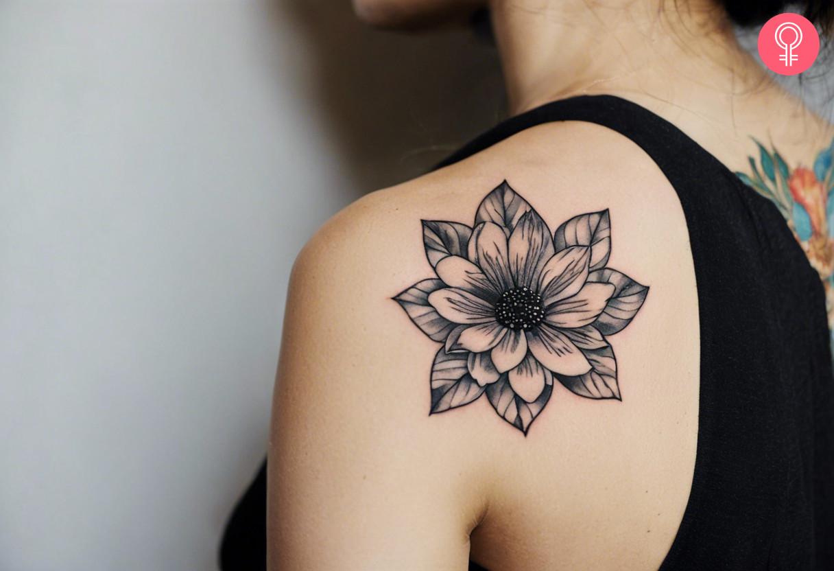 Black illustrative tattoo on shoulder