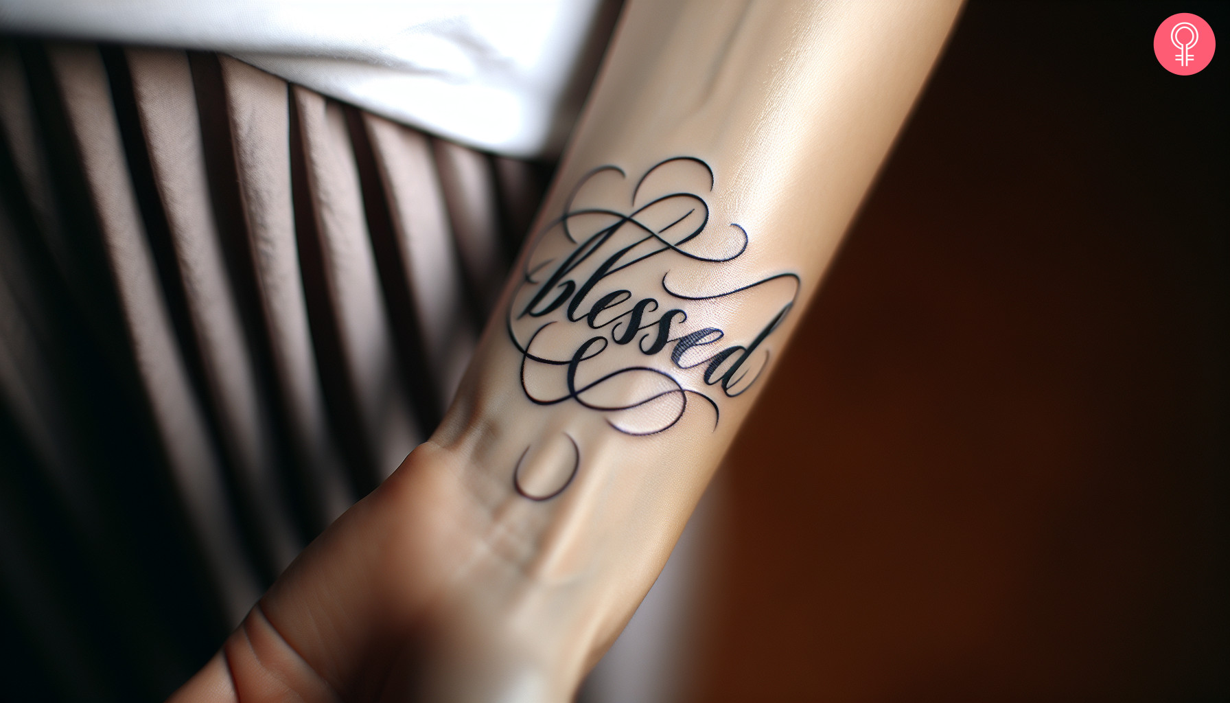 The word blessed inked in cursive on the wrist.