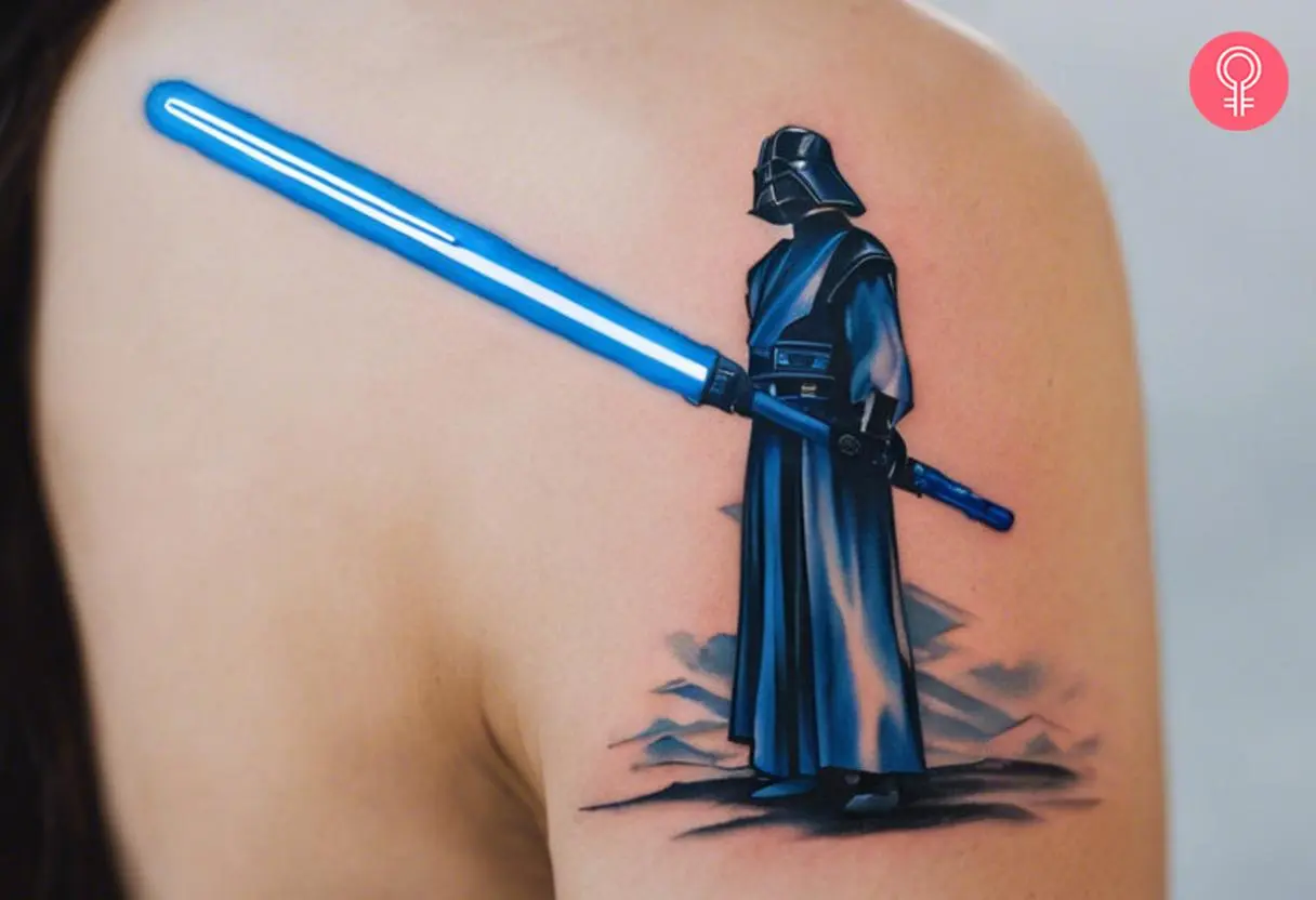 Blue Lightsaber tattoo on a woman’s upper arm