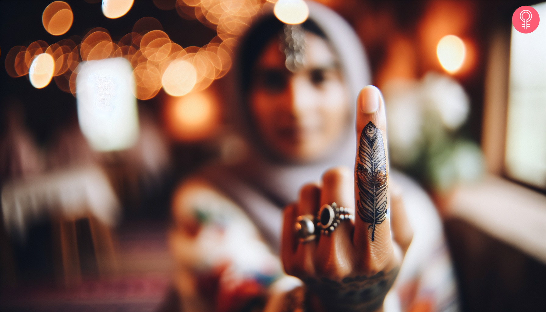 Boho tattoo design on the finger of a woman