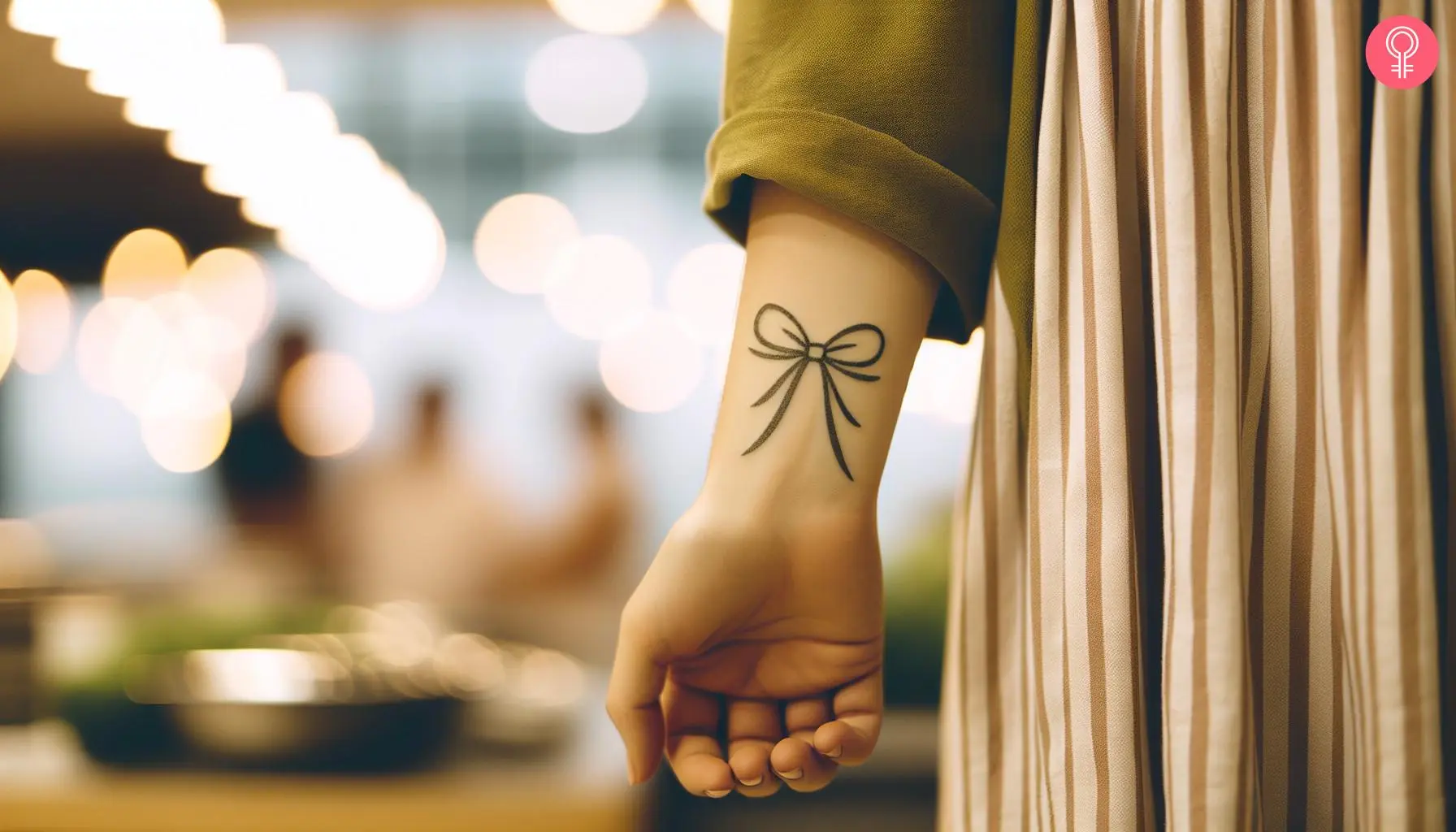 Bow tattoo on the wrist of a woman