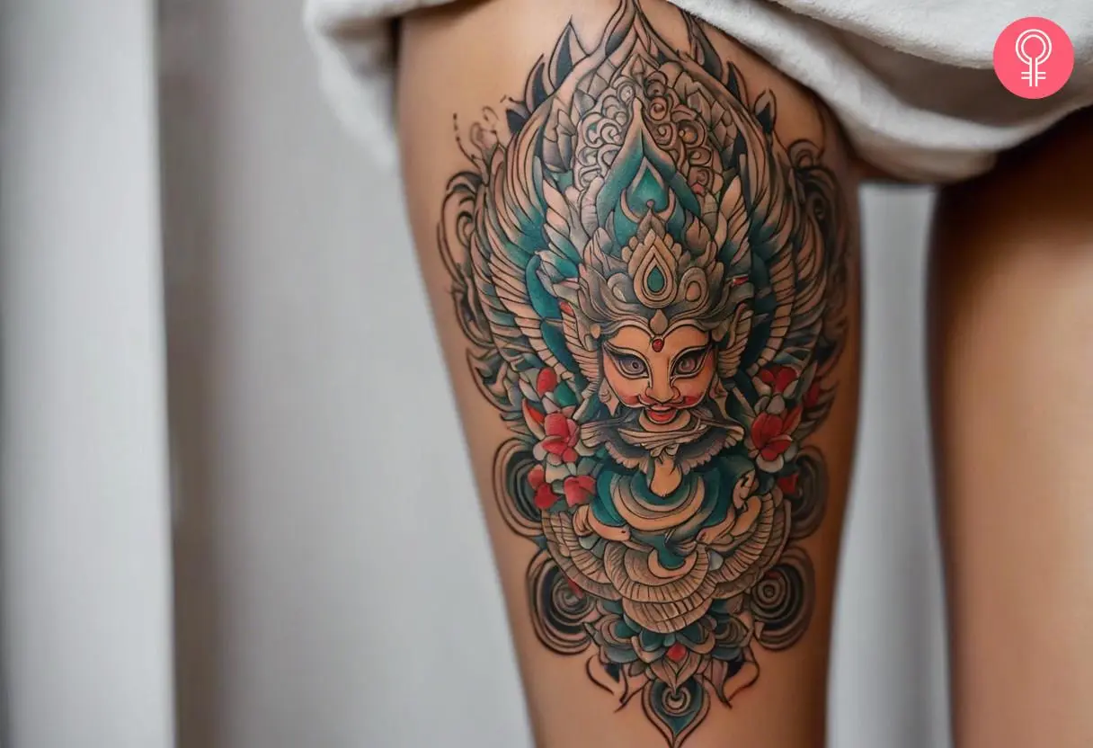 Woman with Buddhist Garuda tattoo on her thigh