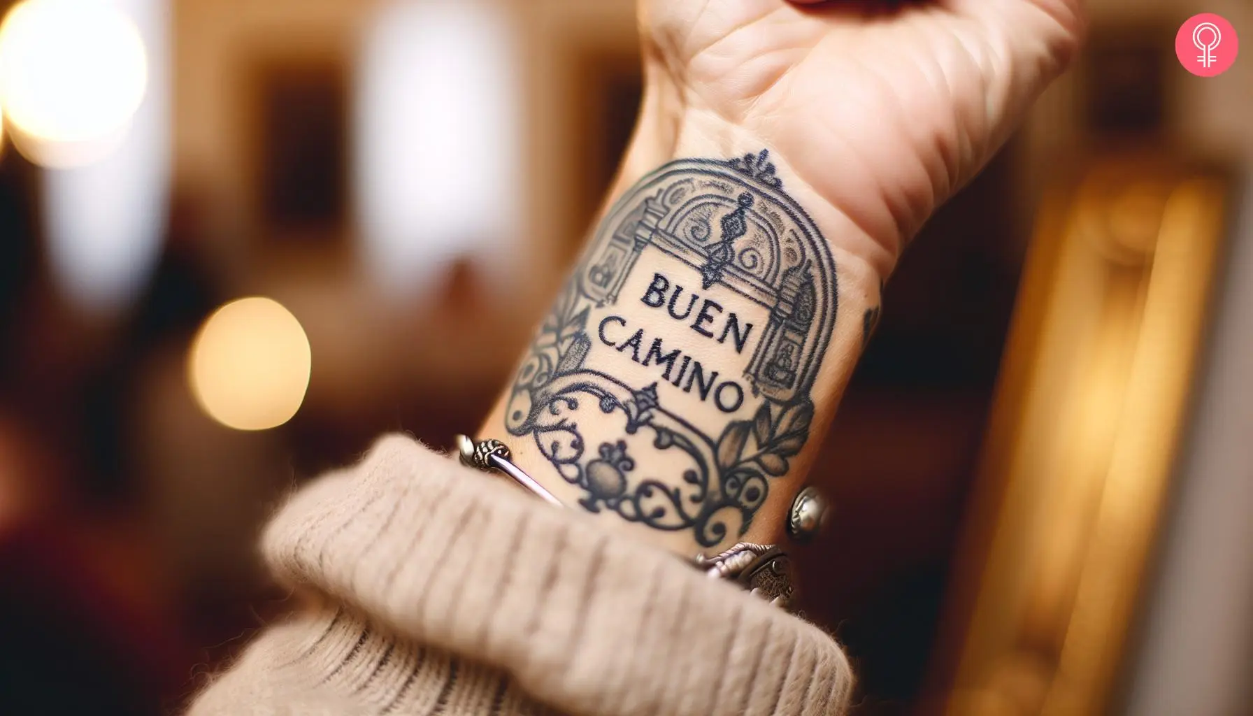 A Buen Camino tattoo on a woman’s forearm