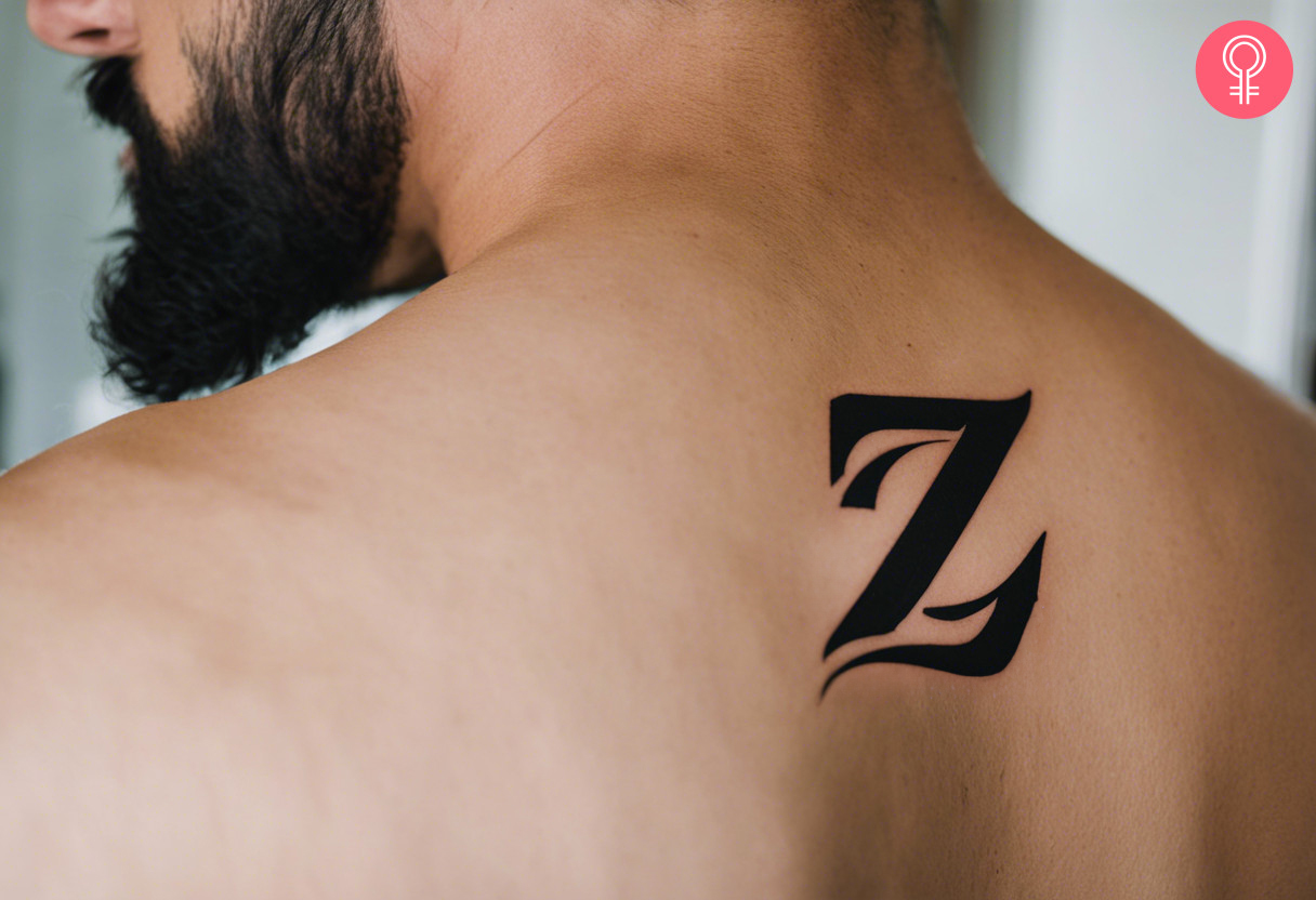 Calligraphy Z tattoo on back of shoulder