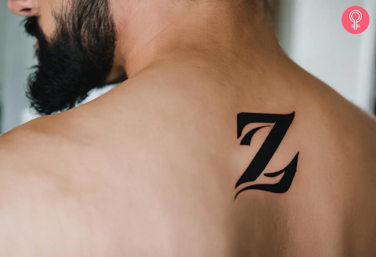 Calligraphy Z tattoo on the back shoulder