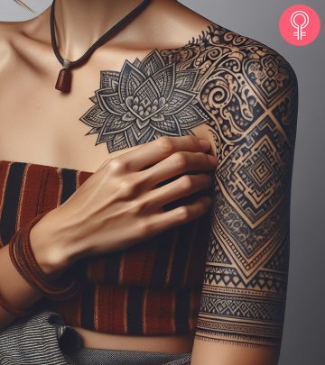 A silver tattoo design on the arm of a woman