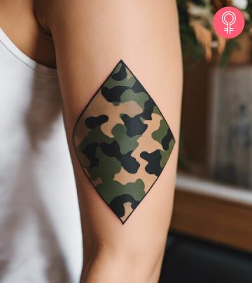 A woman with a colorful tiger rose tattoo on her upper arm