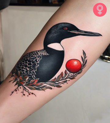 A flying bird tattoo on the upper arm