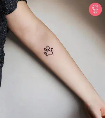 A minimalistic four-leaf clover tattoo on the forearm