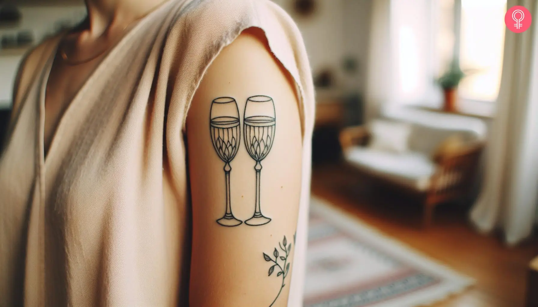 Champagne glasses tattoo on the upper arm of a woman