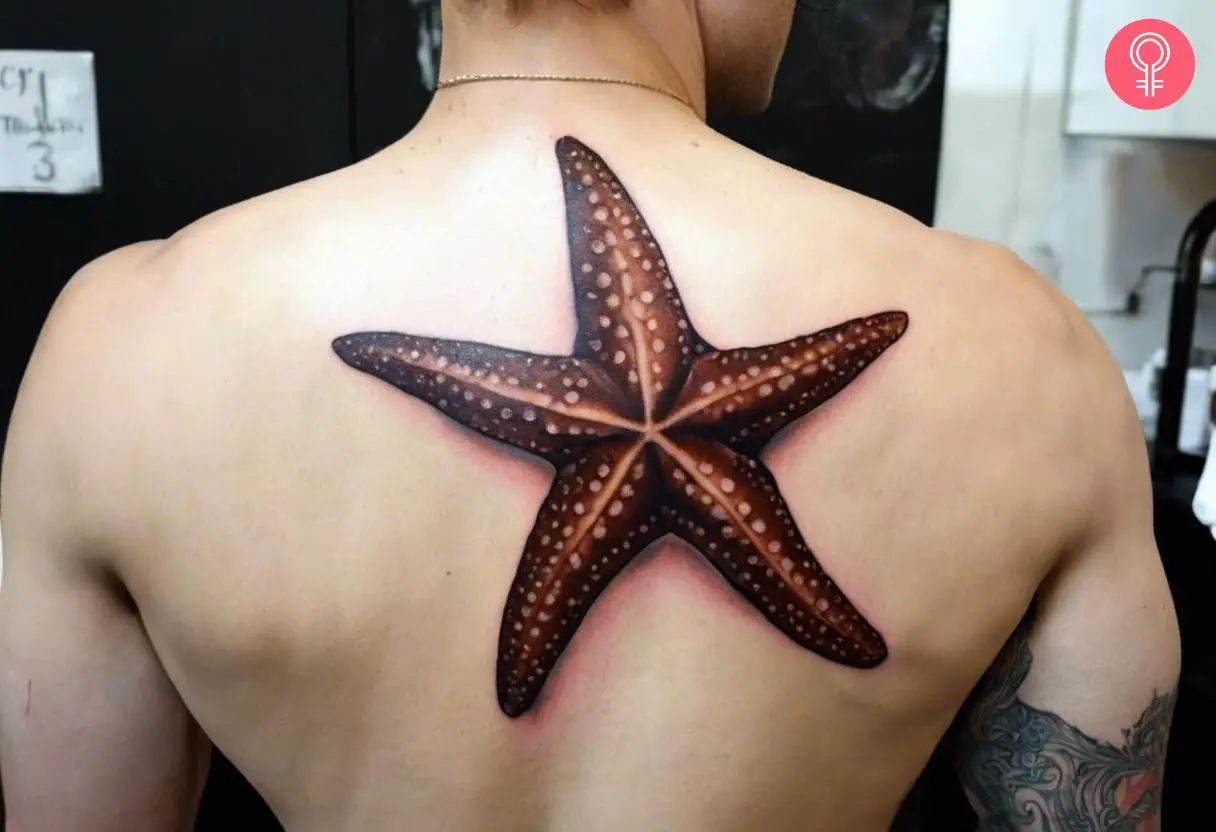 Chocolate starfish tattoo on the upper back