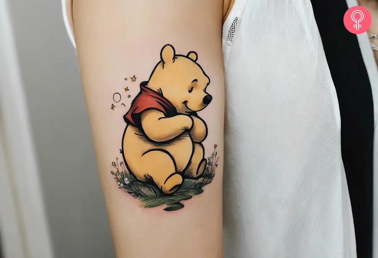 Classic winnie the pooh tattoo on the upper arm