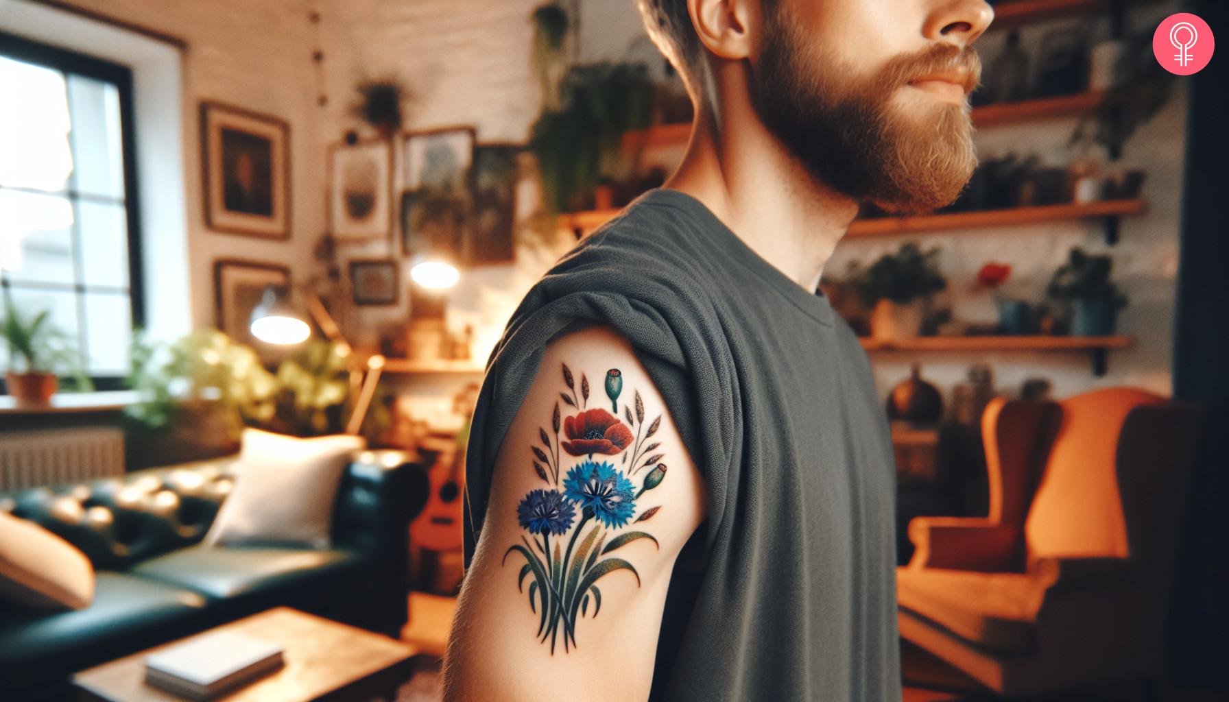 Cornflower and poppy tattoo on the upper arm