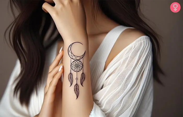 Crescent moon dreamcatcher tattoo on the forearm