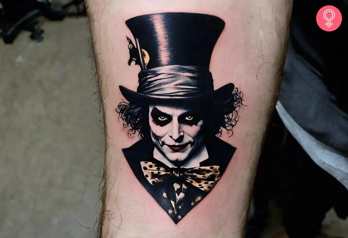 A dark Mad Hatter tattoo on a man’s forearm