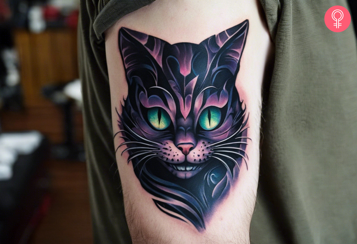Dark cheshire cat tattoo on the upper arm