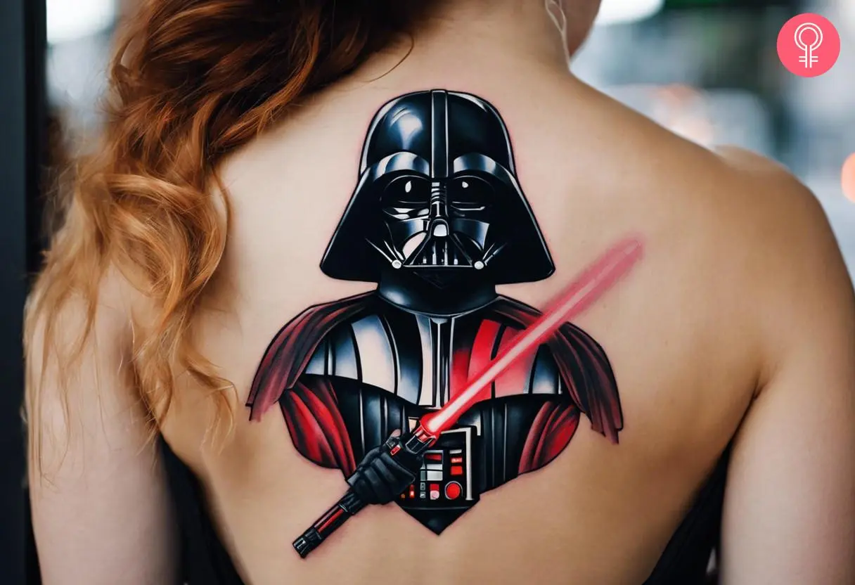 Darth Vader Lightsaber tattoo on a woman’s back