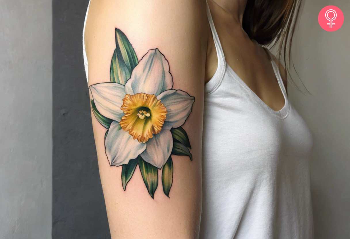 December narcissus flower tattoo on the upper arm