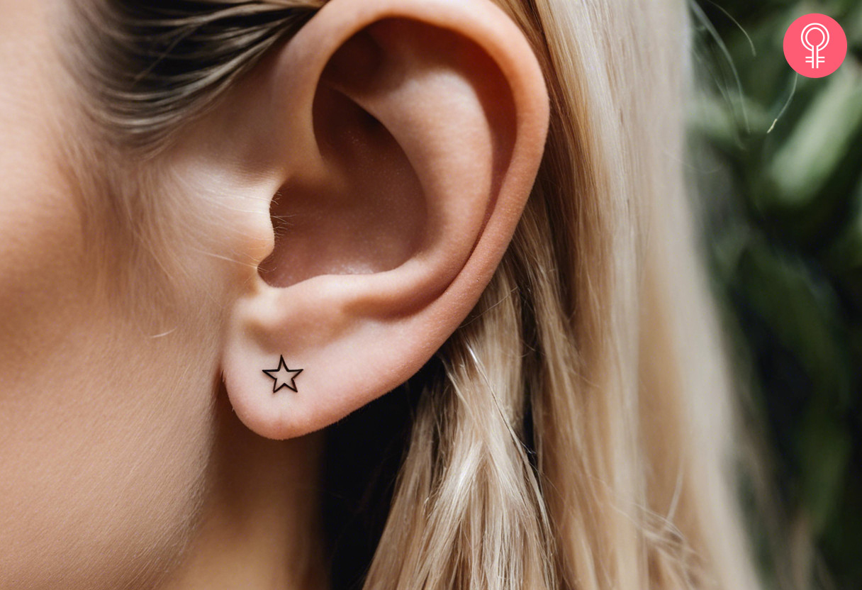 Delicate star tattoo on the ear