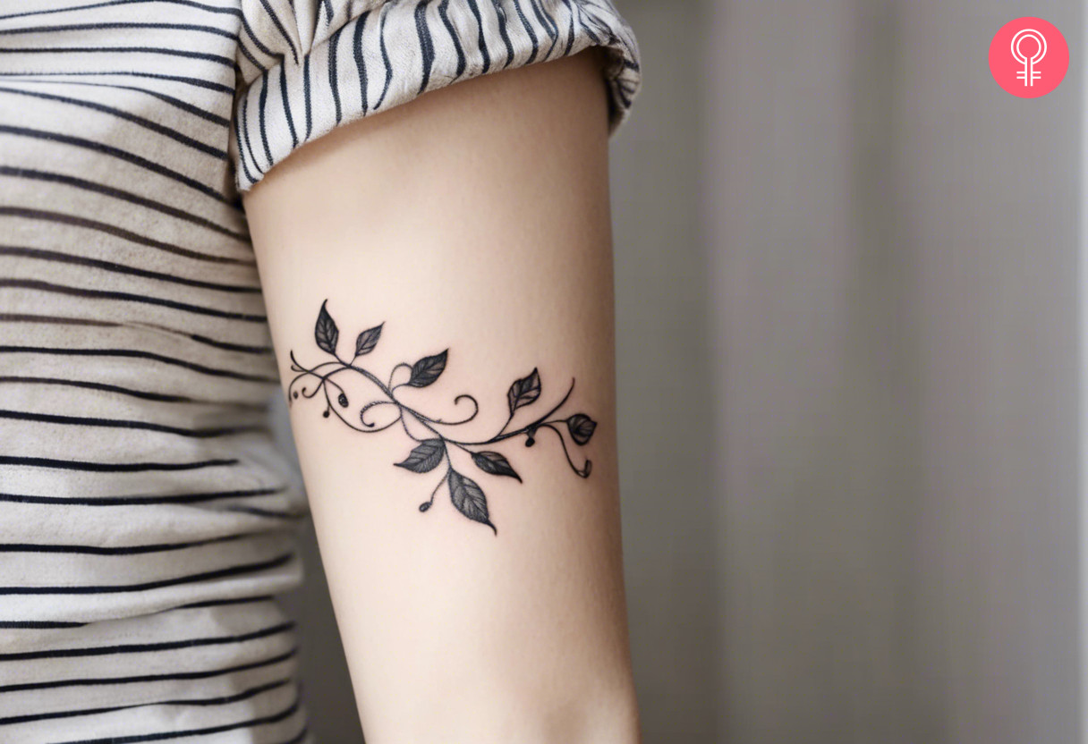 Delicate vine tattoo on the upper arm