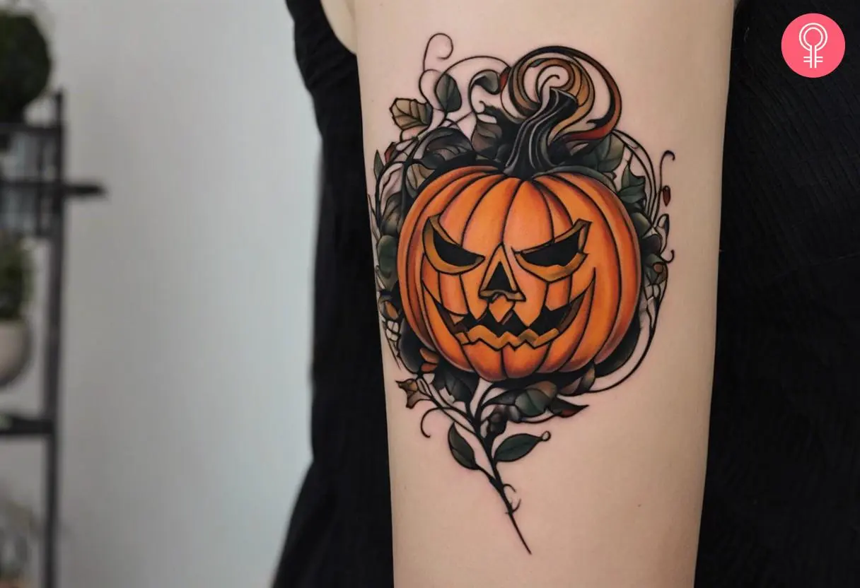 An evil jack-o'-lantern tattoo on the upper arm