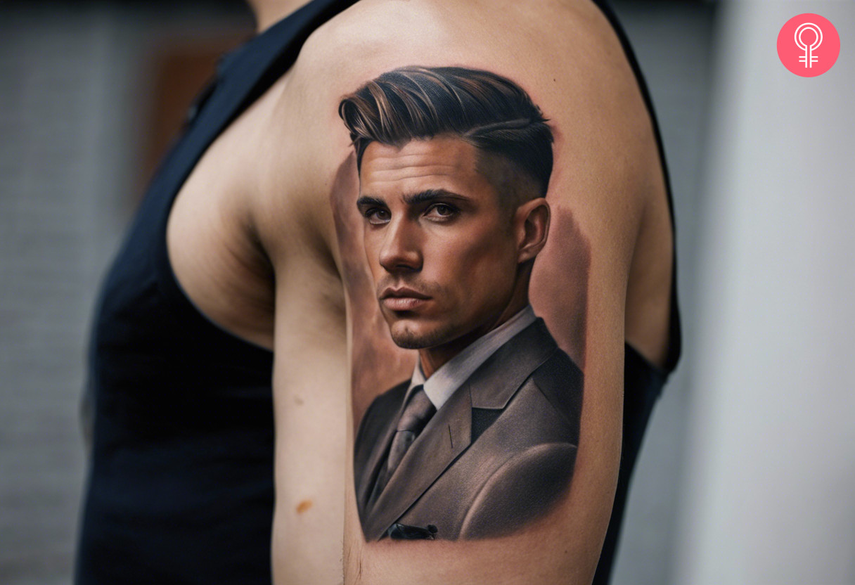 A man wearing a face portrait tattoo on the upper arm