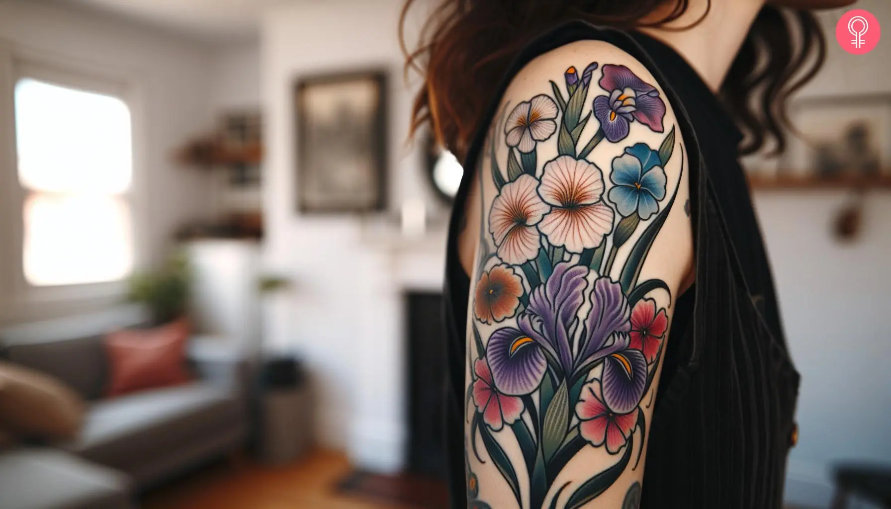 A woman with a colorful February birth flower bouquet tattoo on her upper arm