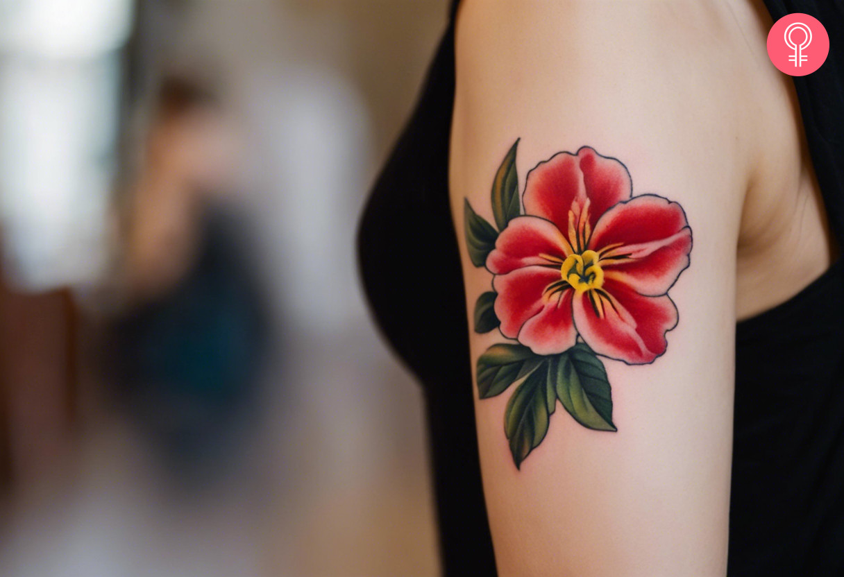 A woman with a red primrose tattoo on her upper arm